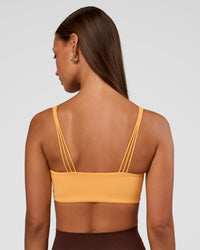Woman wearing Peaches Wrap Sports Bra - Warm Apricot | Model:Brylee | Size:XS