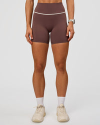 Woman wearing Pinnacle High-Rise 6" Short - Cocoa Powder-Off White | Model:Maja | Size:XS