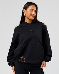 Woman wearing Pride Sticker Boxy Hoodie - Black | Model:Bianca | Size:XS