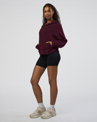 Woman wearing Pursue Mid-Weight Hoodie - Cherry Lacquer | Model:Jordan | Size:XS