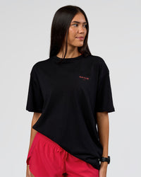 Woman wearing RUN CLUB FLXCotton Tee Oversize - Black-Scarlet | Model:Rhiley | Size:XS
