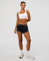 Woman wearing Race Day Sports Bra - White | Model:Brylee | Size:XS