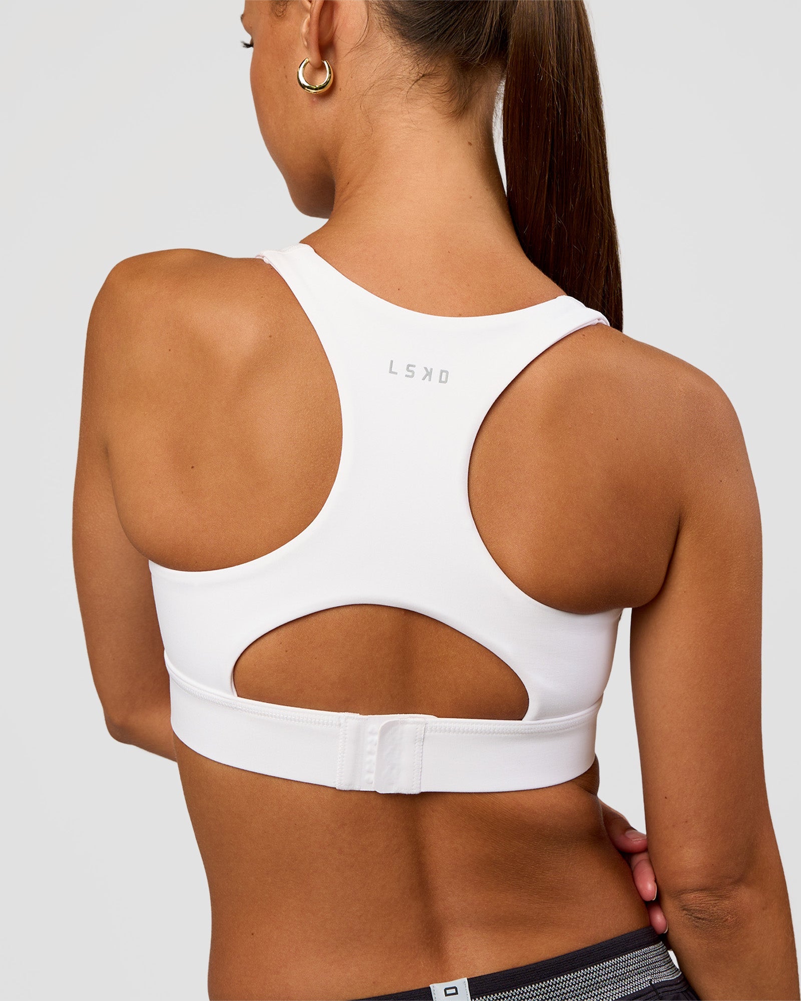 Woman wearing Race Day Sports Bra - White | Model:Brylee | Size:XS
