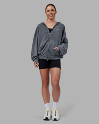 Woman wearing Relentless Washed Zip Through Oversized Hoodie - Dark Storm-White | Model:Kayti | Size:XS