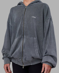 Woman wearing Relentless Washed Zip Through Oversized Hoodie - Dark Storm-White | Model:Kayti | Size:XS