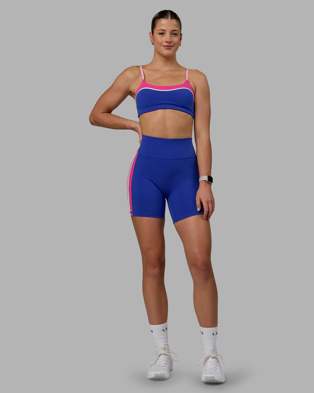 Woman wearing Revitalise Mid Short Tights - Power Cobalt-Fuchsia Pink