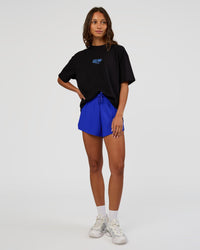 Woman wearing Run Club Script FLXCotton Oversized Tee - Black-Palace Blue | Model:Dakota | Size:XS