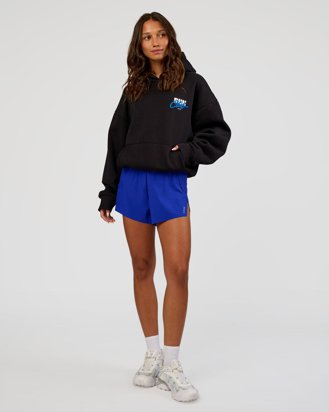 Woman wearing Run Club Script Oversized Hoodie - Black-Palace Blue | Model:Dakota | Size:XS