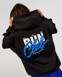 Woman wearing Run Club Script Oversized Hoodie - Black-Palace Blue | Model:Dakota | Size:XS