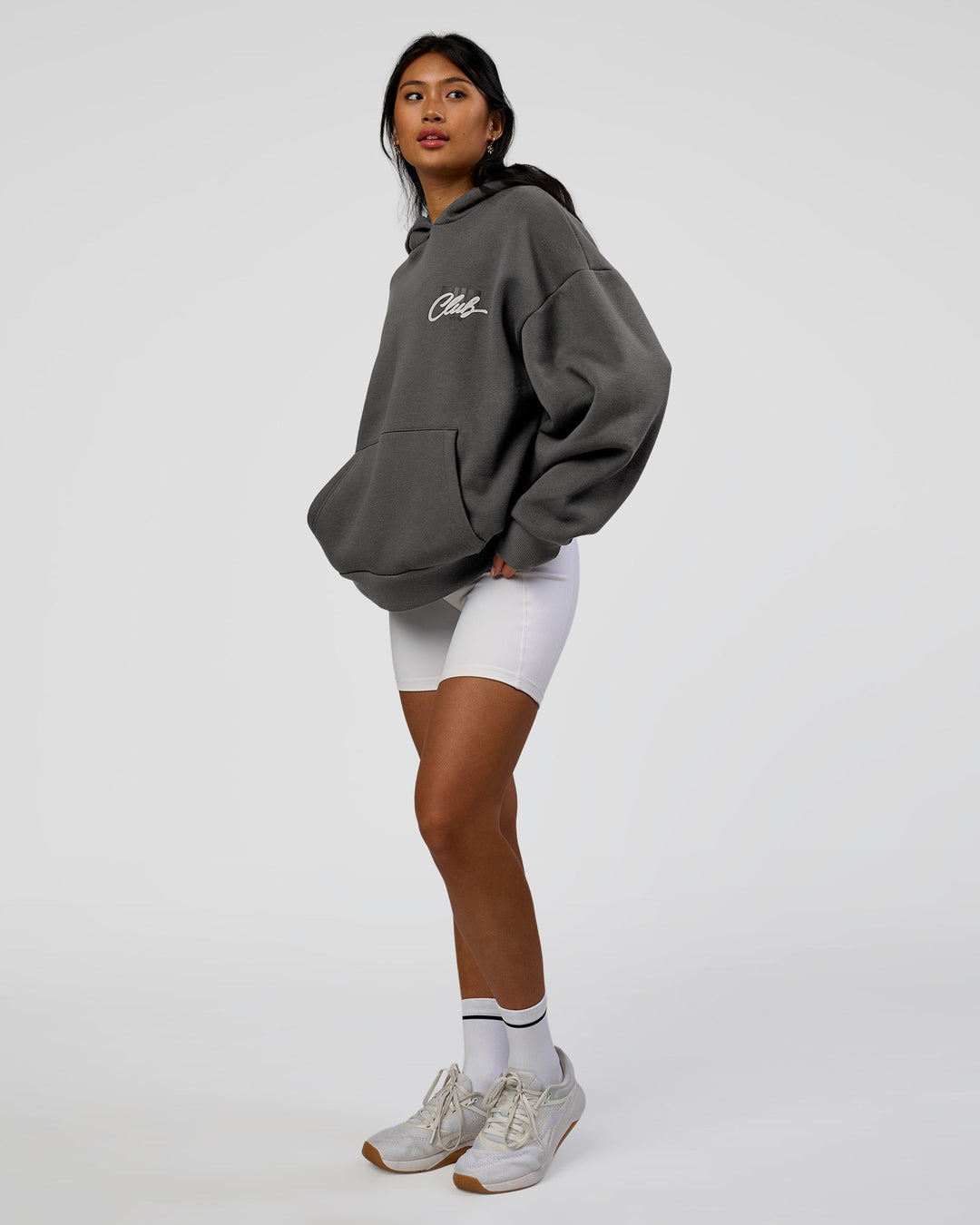 Woman wearing Run Club Script Oversized Hoodie - Dark Storm-Alloy | Model:Loren | Size:XS