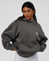 Woman wearing Run Club Script Oversized Hoodie - Dark Storm-Alloy | Model:Loren | Size:XS