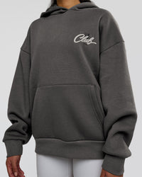 Woman wearing Run Club Script Oversized Hoodie - Dark Storm-Alloy | Model:Loren | Size:XS