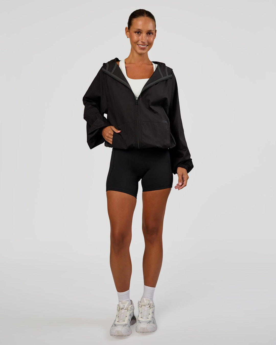 Woman wearing Run Light Jacket - Black | Model:Brylee | Size:XS