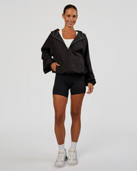 Woman wearing Run Light Jacket - Black | Model:Brylee | Size:XS