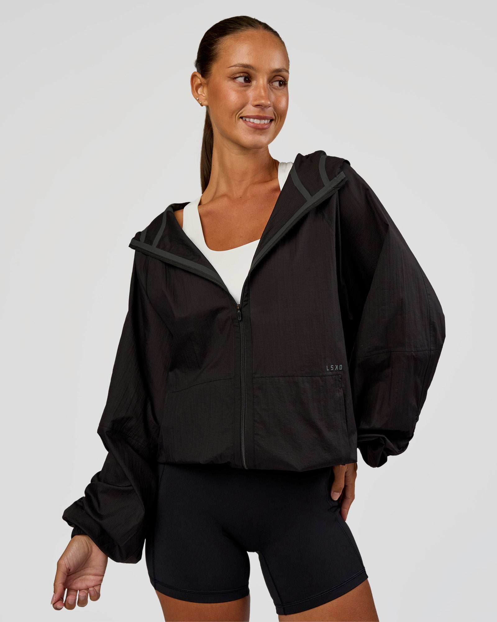 Woman wearing Run Light Jacket - Black | Model:Brylee | Size:XS