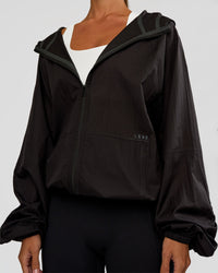 Woman wearing Run Light Jacket - Black | Model:Brylee | Size:XS