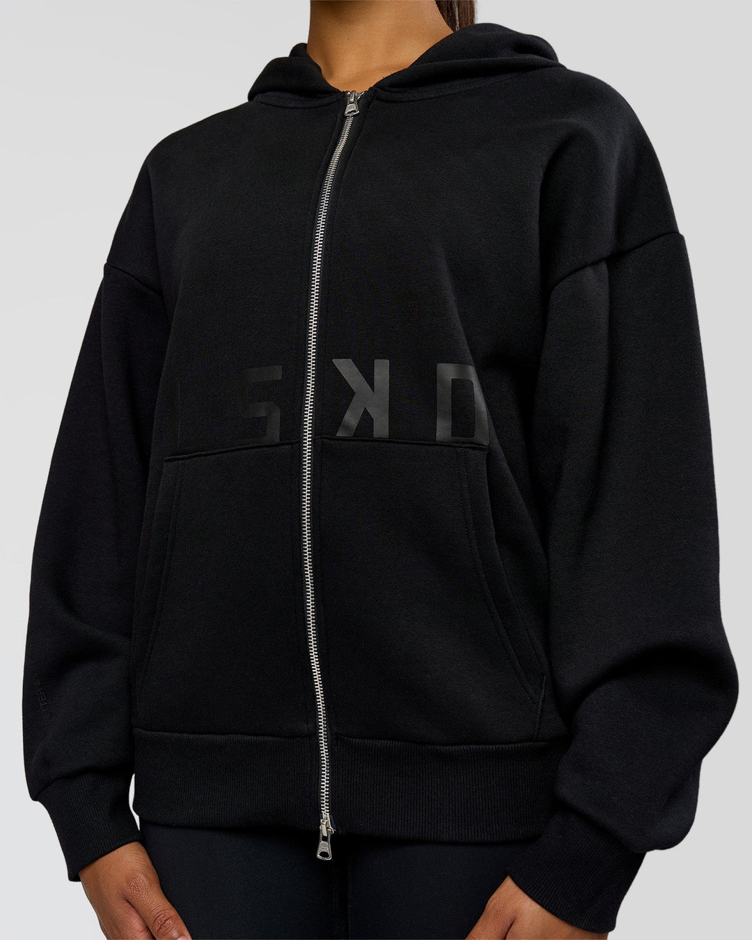 Woman wearing Shadow Mode Oversized Zip Through Hoodie - Black | Model:Rosie | Size:XS