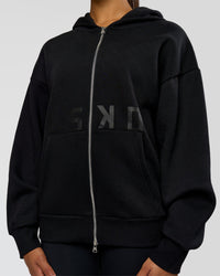 Woman wearing Shadow Mode Oversized Zip Through Hoodie - Black | Model:Rosie | Size:XS