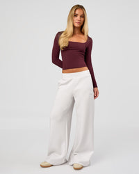 Woman wearing Show It Off Long Sleeve Top in Cherry Lacquer | Model:Issy | Size:XS