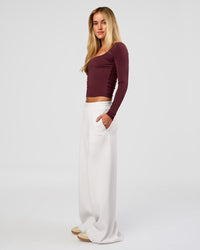Woman wearing Show It Off Long Sleeve Top in Cherry Lacquer | Model:Issy | Size:XS