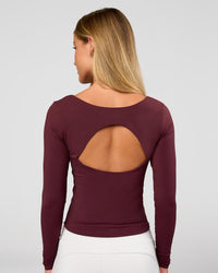 Woman wearing Show It Off Long Sleeve Top in Cherry Lacquer | Model:Issy | Size:XS