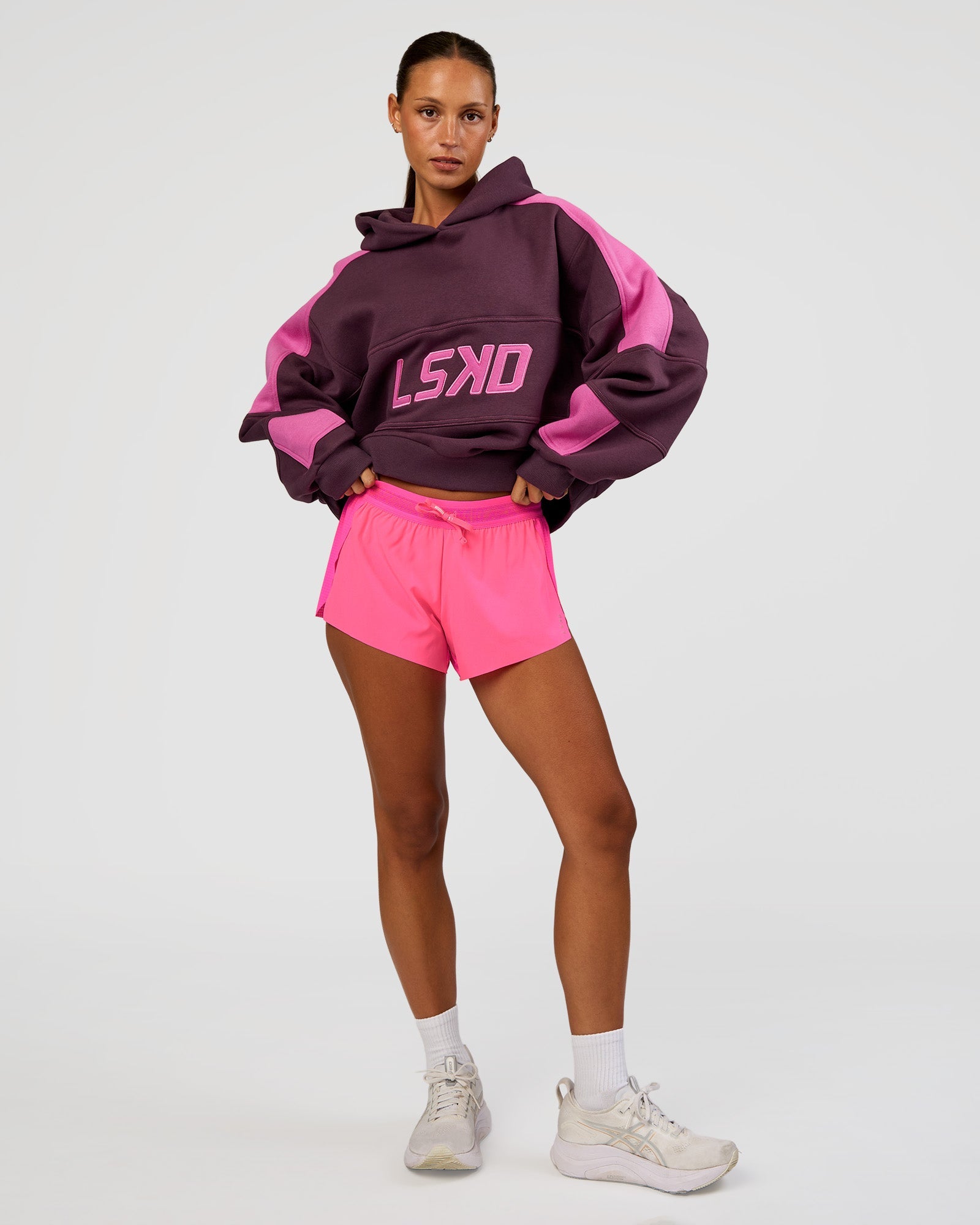 Woman wearing Slam Cropped Oversized Hoodie - Midnight Plum-Ultra Fuchsia | Model:Brylee | Size:XS