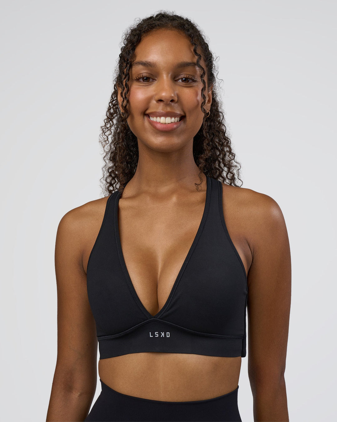 Woman wearing Stamina Sports Bra D/DD/E - Black | Model:Jordan | Size:XS - view 3