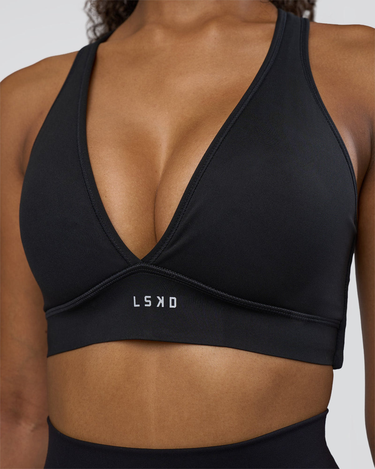 Woman wearing Stamina Sports Bra D/DD/E - Black | Model:Jordan | Size:XS - view 1