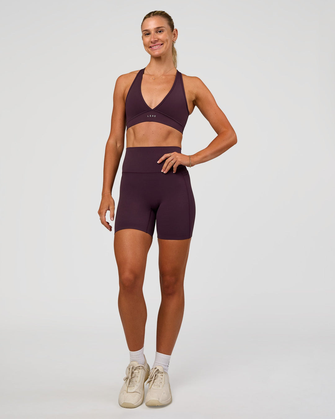 Woman wearing Stamina Sports Bra - Midnight Plum | Model:Emelia | Size:XS