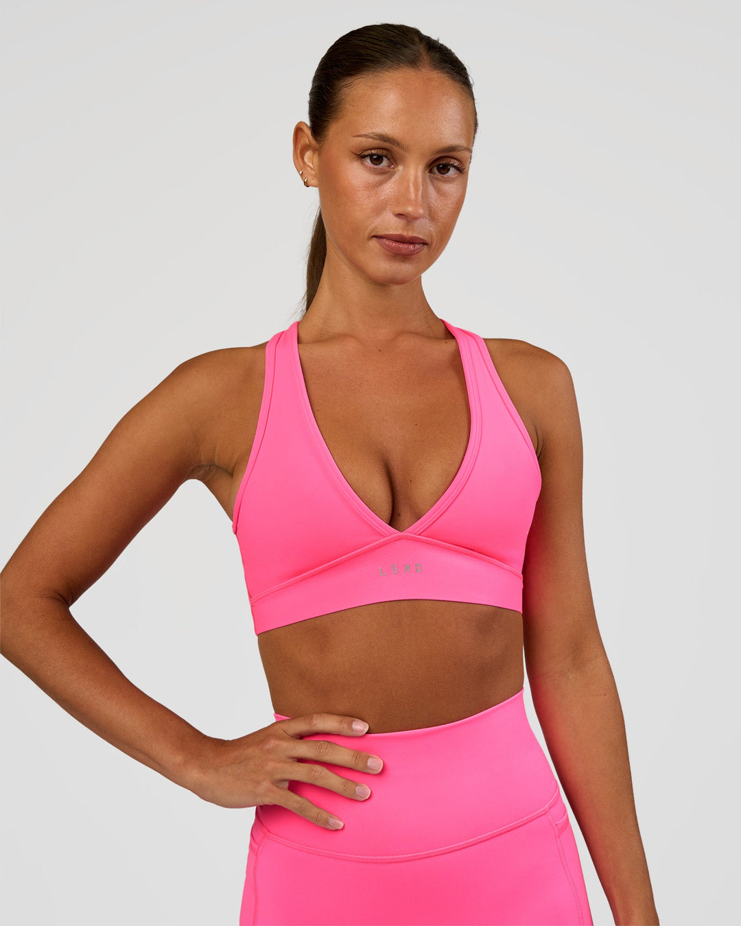 Woman wearing Stamina Sports Bra - Sugar Plum | Set:true | Angle:front | Model:Brylee | Size:XS