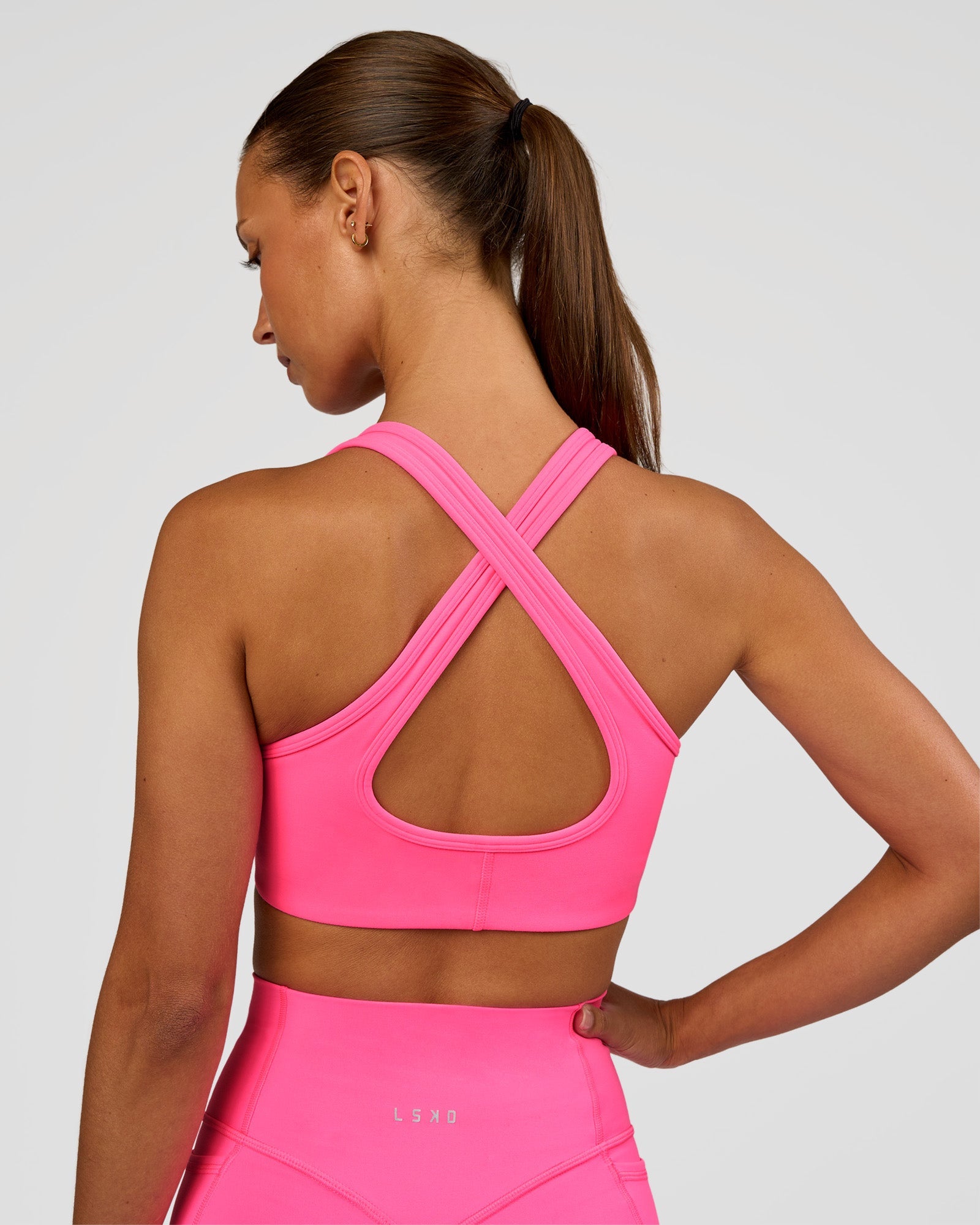 Woman wearing Stamina Sports Bra - Sugar Plum | Set:true | Angle:back | Model:Brylee | Size:XS