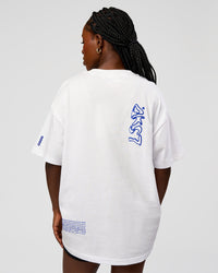 Woman wearing Static Grit Heavyweight Oversized Tee - White-Electric Indigo | Model:Ellie | Size:XS