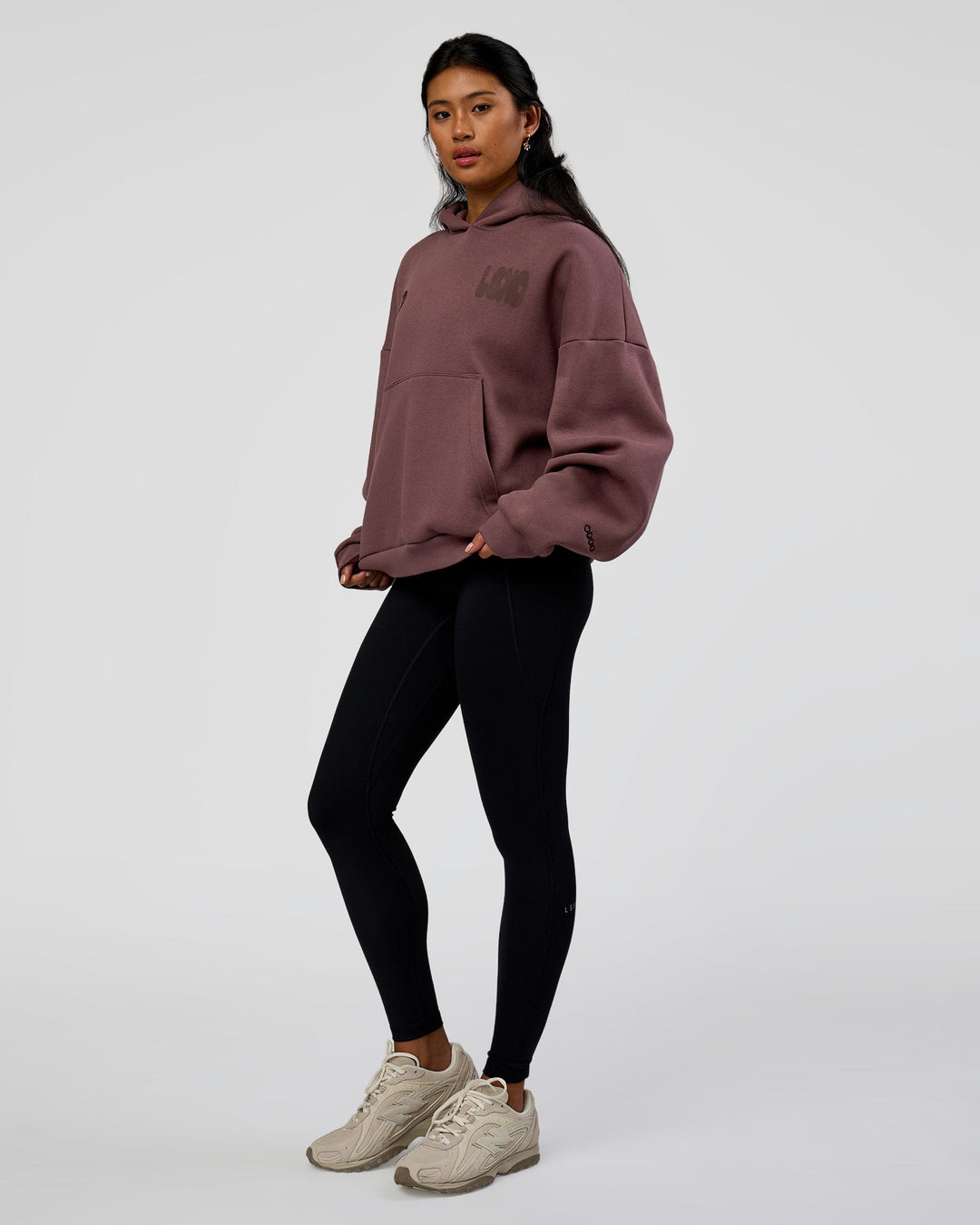 Woman wearing Static Grit Unisex Boxy Hoodie - Cocoa Powder-Hot Chocolate | Model:Loren | Size:XS