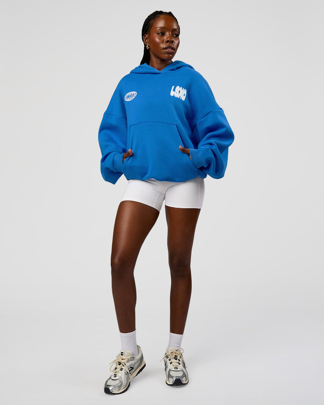 Woman wearing Static Grit Unisex Boxy Hoodie - Palace Blue-White | Model:Ellie | Size:XS
