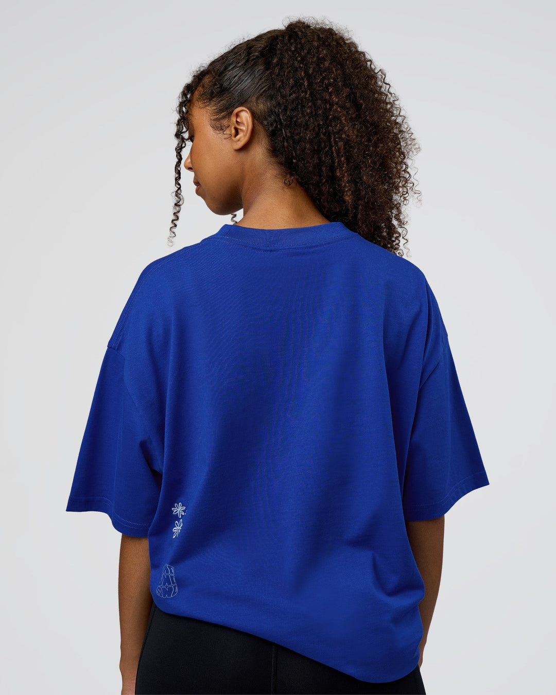 Woman wearing Sticker Heavyweight Oversized Tee - Electric Indigo-Baltic Sea | Model:Jordan | Size:XS