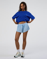Woman wearing Sticker Heavyweight Oversized Tee - Electric Indigo-Baltic Sea | Model:Jordan | Size:XS