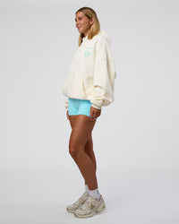 Woman wearing Sticker Unisex Oversized Hoodie - Off White-Jelly Mint | Model:Amity | Size:XS