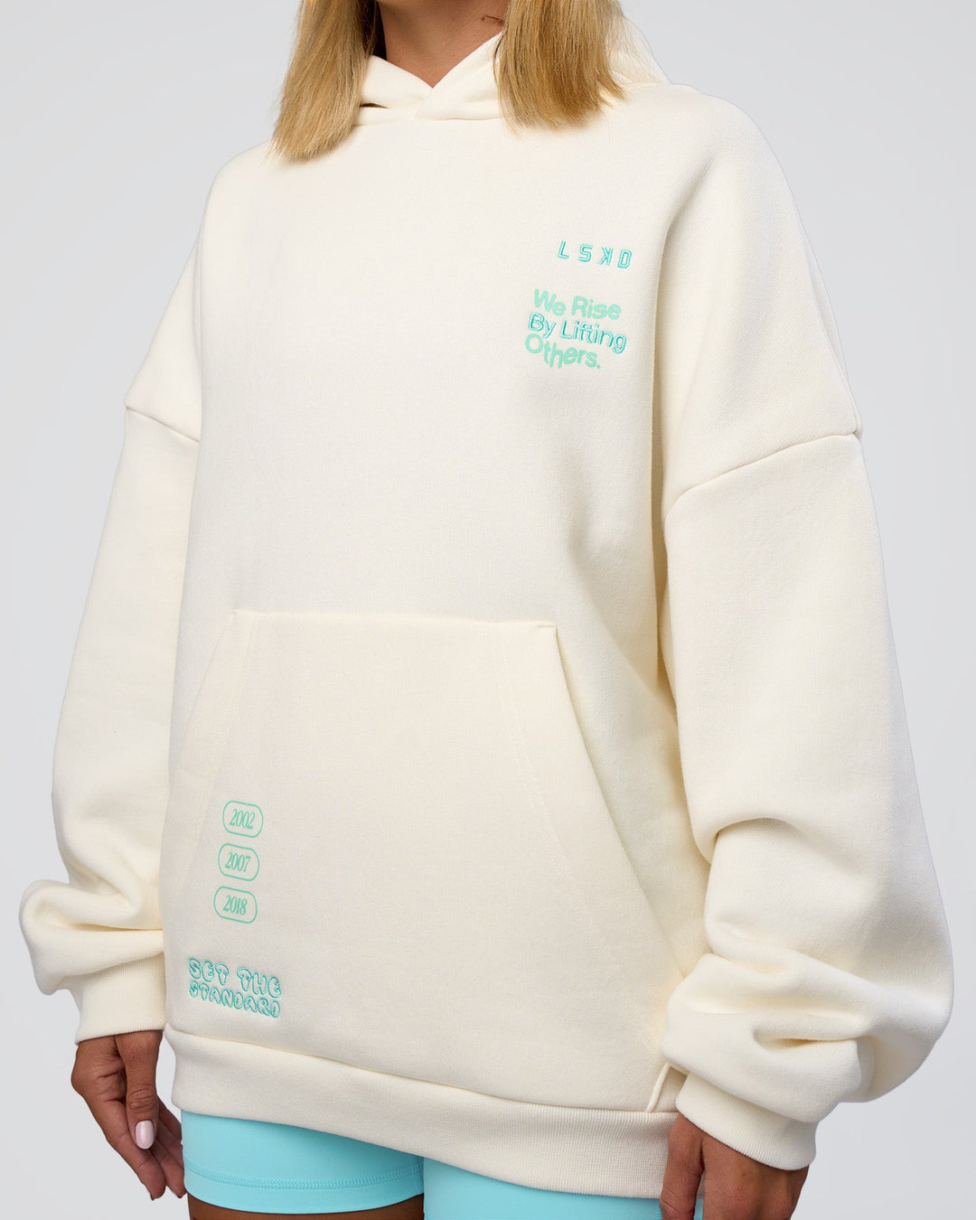 Woman wearing Sticker Unisex Oversized Hoodie - Off White-Jelly Mint | Model:Amity | Size:XS