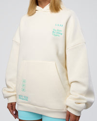 Woman wearing Sticker Unisex Oversized Hoodie - Off White-Jelly Mint | Model:Amity | Size:XS