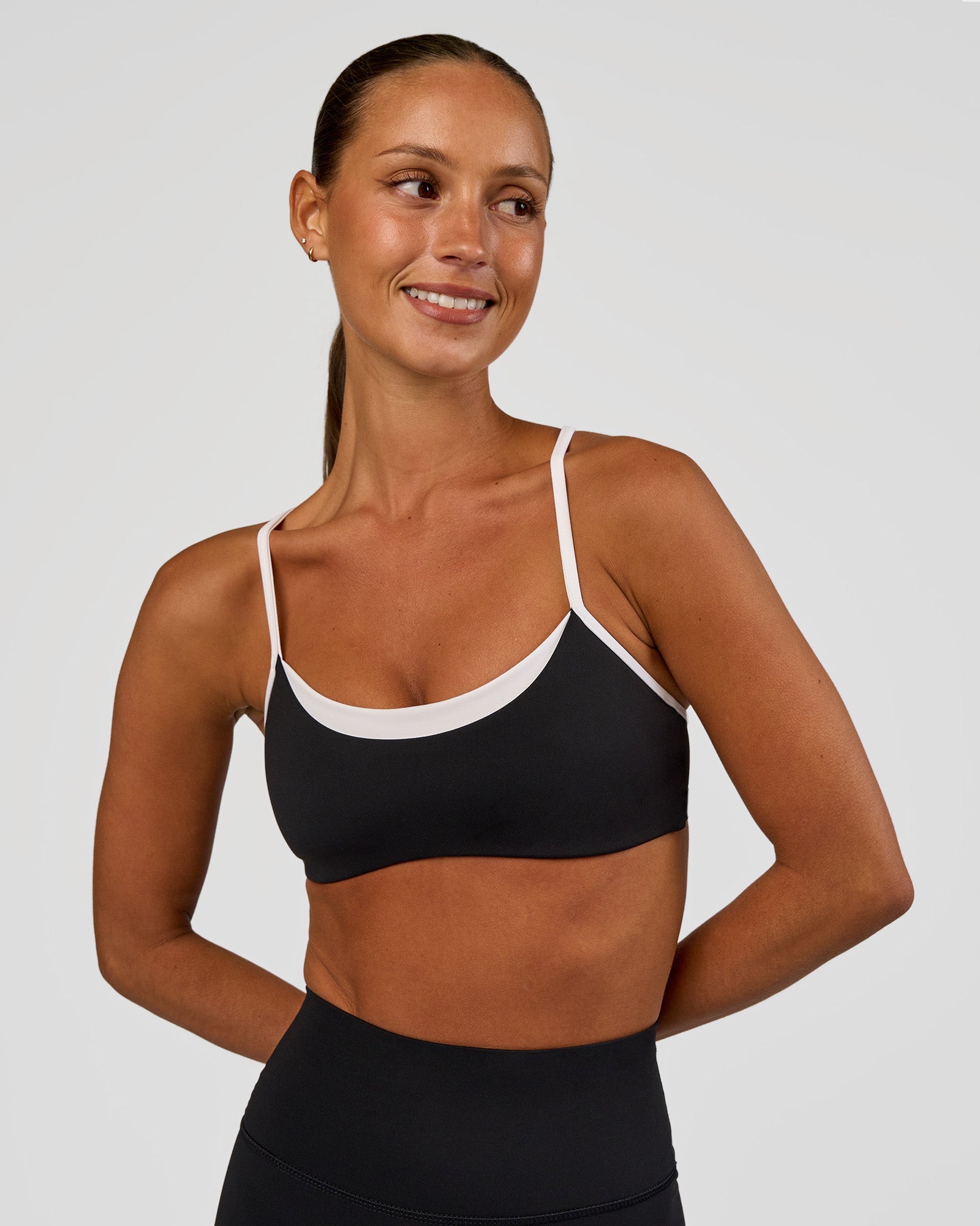 Woman wearing Tempo Sports Bra - Black-White | Model:Brylee | Size:XS