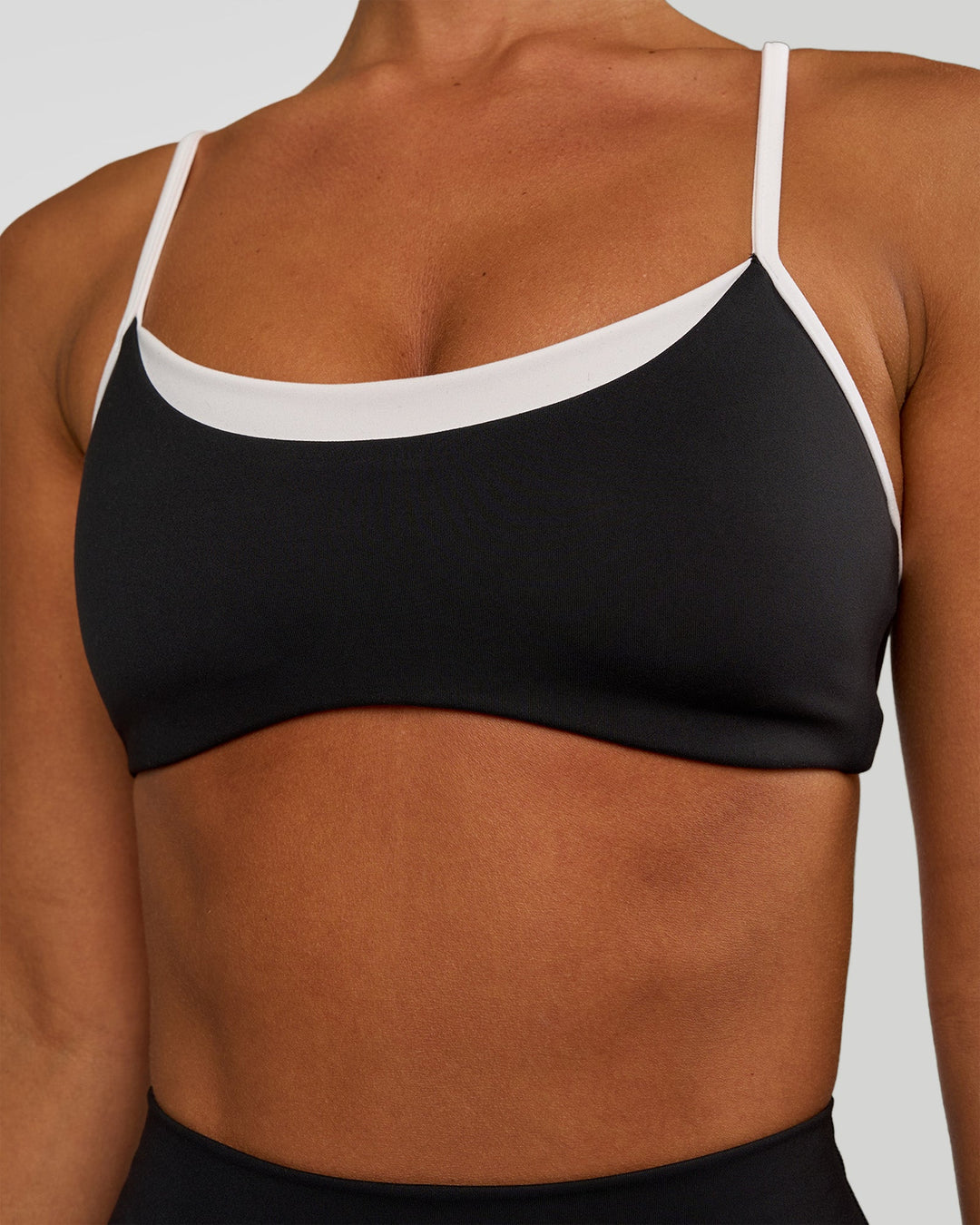 Woman wearing Tempo Sports Bra - Black-White | Model:Brylee | Size:XS