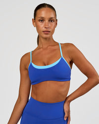 Woman wearing Tempo Sports Bra - Electric Indigo-Baltic Sea | Model:Brylee | Size:XS
