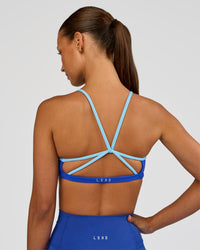 Woman wearing Tempo Sports Bra - Electric Indigo-Baltic Sea | Model:Brylee | Size:XS