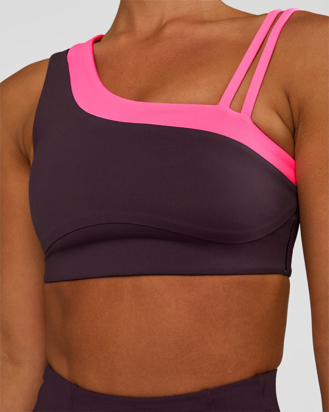 Woman wearing Thrive Asymmetric Sports Bra - Midnight Plum-Sugar Plum | Model:Brylee | Size:XS