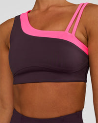 Woman wearing Thrive Asymmetric Sports Bra - Midnight Plum-Sugar Plum | Model:Brylee | Size:XS