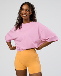 Woman wearing Together We Rise FLXCotton Oversized Tee - Bubblegum-Warm Apricot | Model:Jordan | Size:L