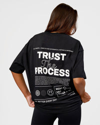 Woman wearing Trust The Process Heavyweight Unisex Oversized Tee - Black-White | Model:Kirstyn | Size:XS