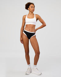 Woman wearing Turbo Track Brief in Black-White| Model:Txai | Size:XS
