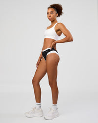 Woman wearing Turbo Track Brief in Black-White| Model:Txai | Size:XS