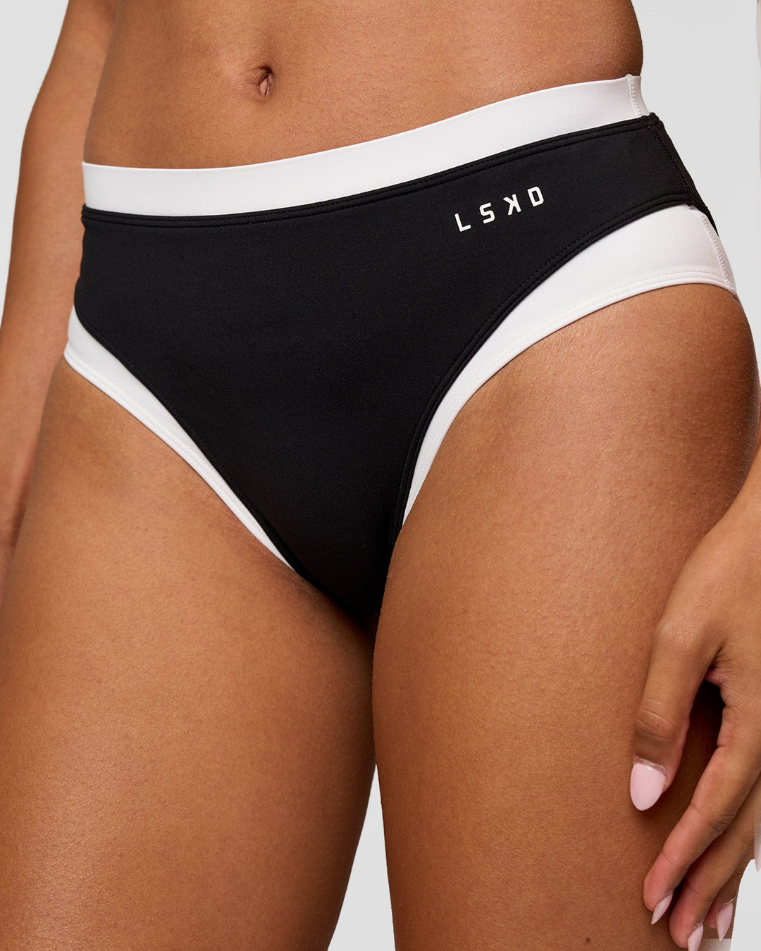 Woman wearing Turbo Track Brief in Black-White| Model:Txai | Size:XS